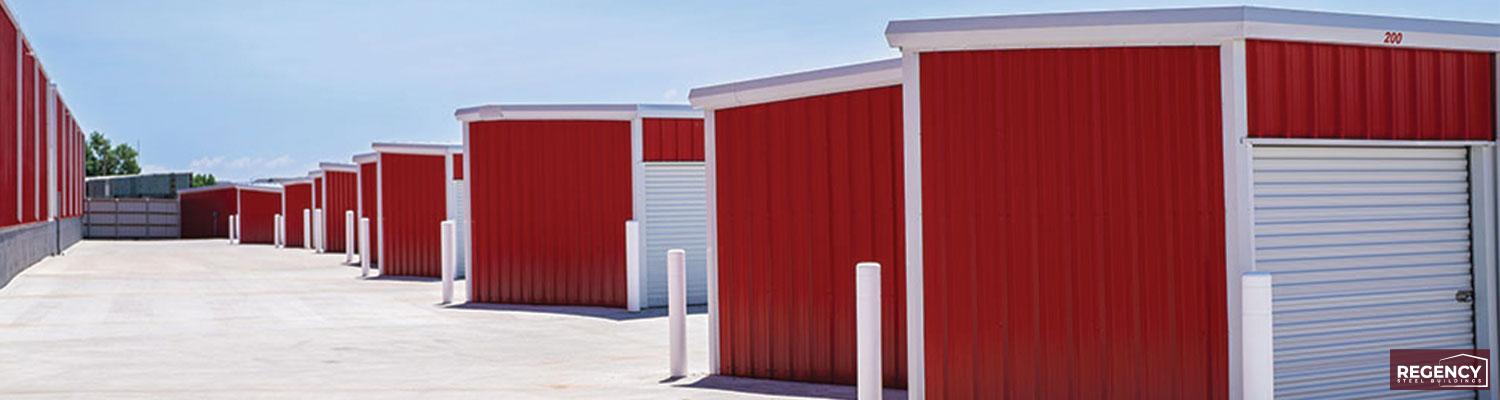 Red Mini Storage Buildings Lined Up with a Blue Sky in the Background